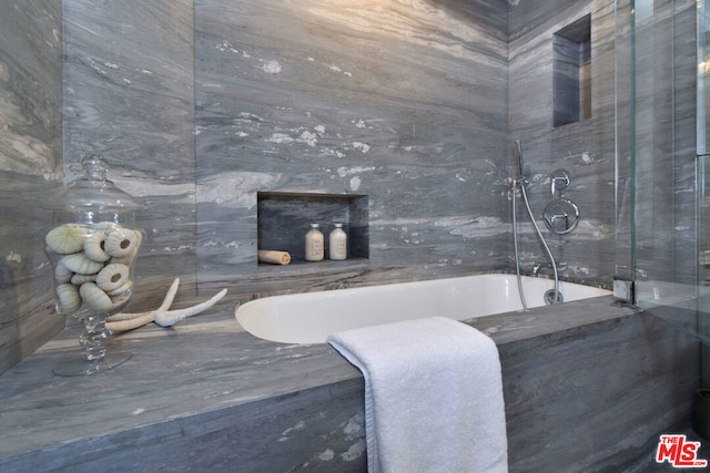 bathroom featuring tile walls