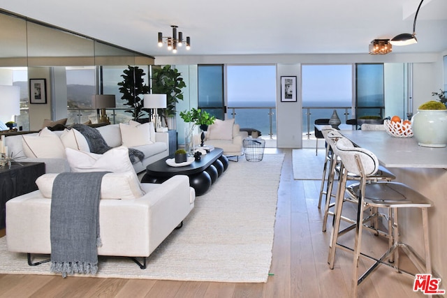 living room featuring light hardwood / wood-style floors and an inviting chandelier