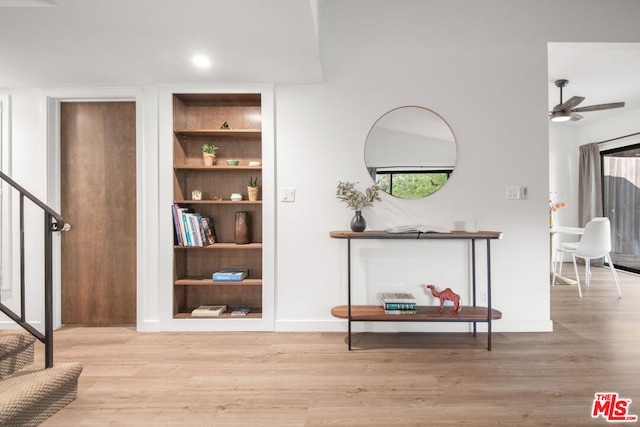 corridor with light hardwood / wood-style floors