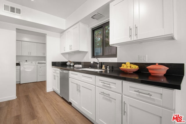 kitchen with dishwasher, sink, independent washer and dryer, light hardwood / wood-style floors, and white cabinets