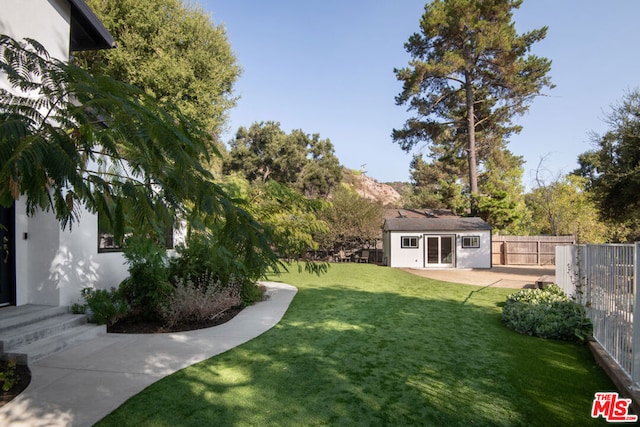 view of yard with an outdoor structure and a patio