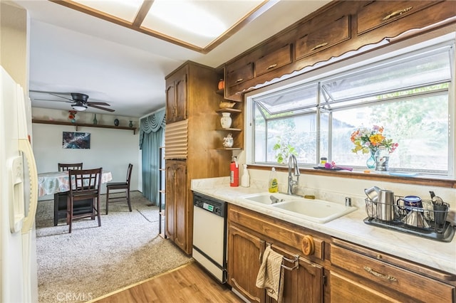 kitchen with light hardwood / wood-style flooring, ceiling fan, sink, and white appliances