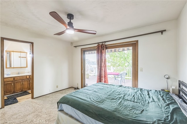 bedroom with access to outside, sink, ensuite bath, ceiling fan, and light colored carpet