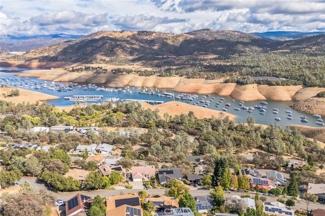 birds eye view of property featuring a water and mountain view