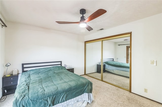 carpeted bedroom with a closet and ceiling fan