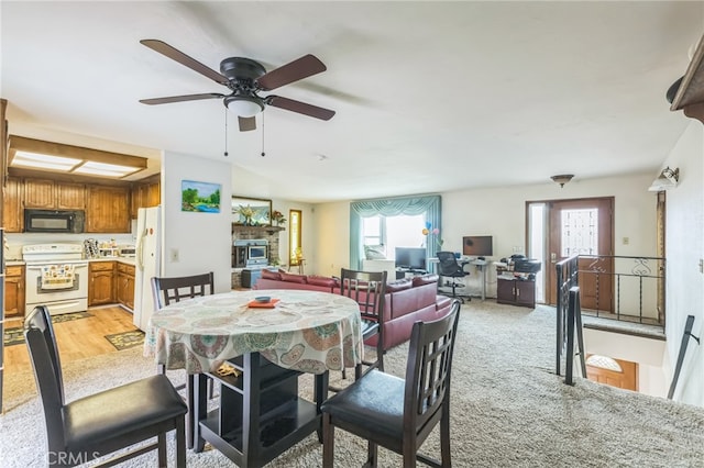 dining room with light hardwood / wood-style flooring and ceiling fan