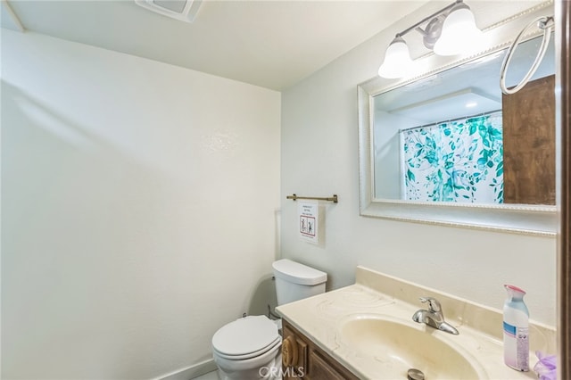 bathroom featuring vanity and toilet