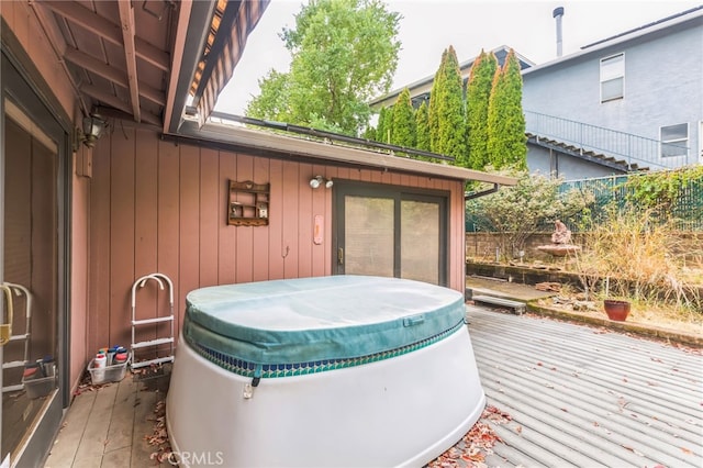 wooden deck with a hot tub