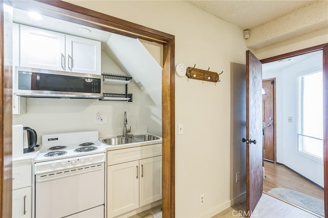 kitchen with sink, white range with electric stovetop, white cabinetry, a textured ceiling, and light hardwood / wood-style floors