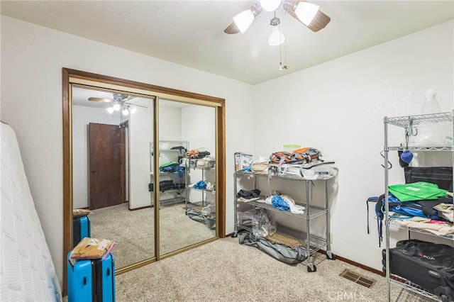 carpeted bedroom featuring a closet and ceiling fan