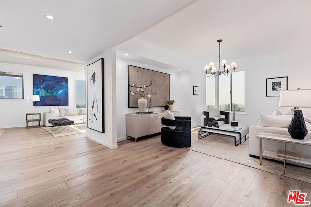 living room with a chandelier and light wood-type flooring