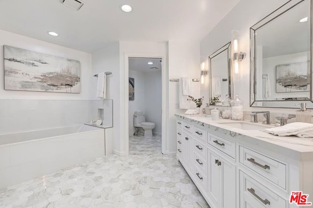 bathroom featuring vanity, toilet, and a bath