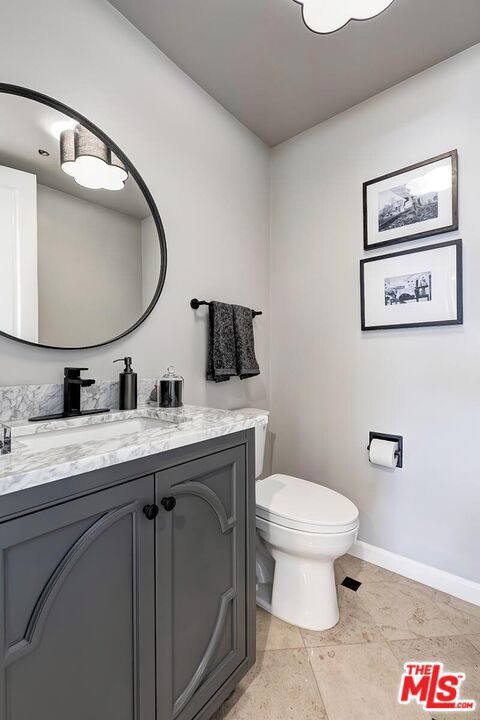 bathroom featuring tile patterned floors, vanity, and toilet