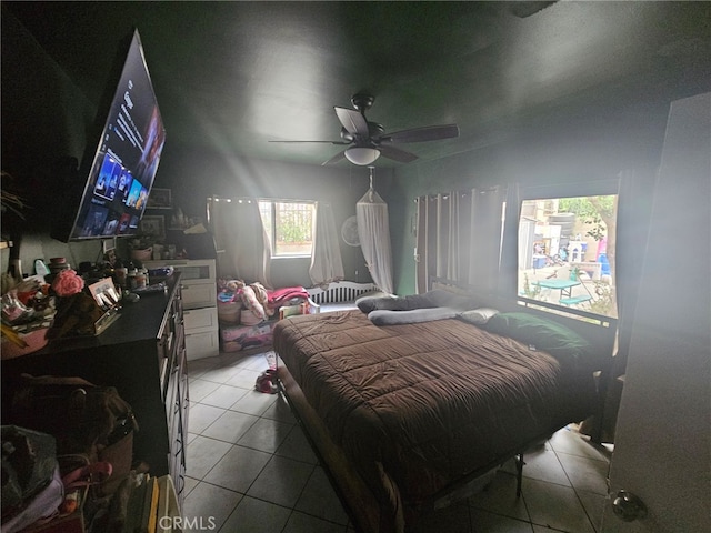 tiled bedroom with ceiling fan