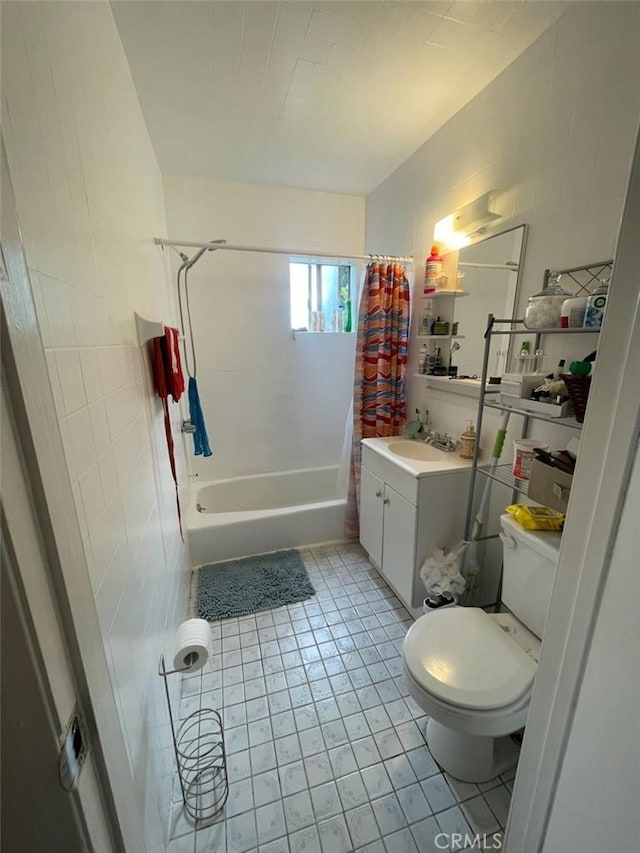 full bathroom with vanity, tile patterned floors, shower / bath combination with curtain, toilet, and tile walls