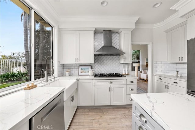 kitchen with ornamental molding, dishwasher, wall chimney exhaust hood, black gas stovetop, and tasteful backsplash