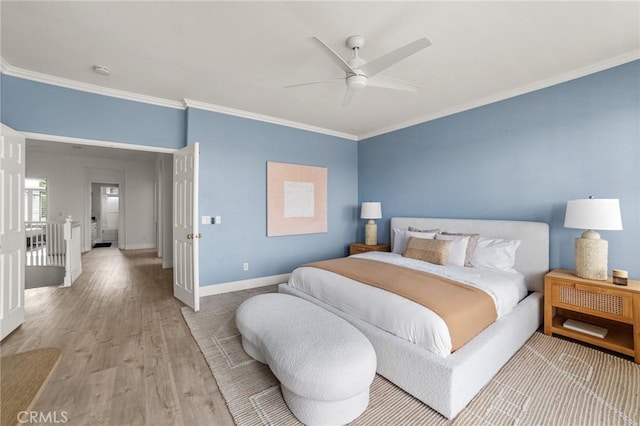 bedroom featuring ceiling fan, baseboards, wood finished floors, and ornamental molding