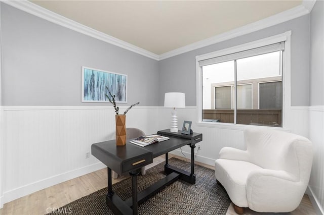 home office featuring wainscoting, crown molding, and wood finished floors