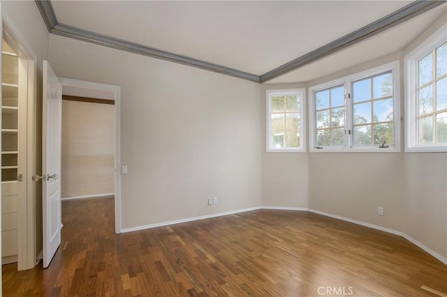 unfurnished room with hardwood / wood-style floors and ornamental molding