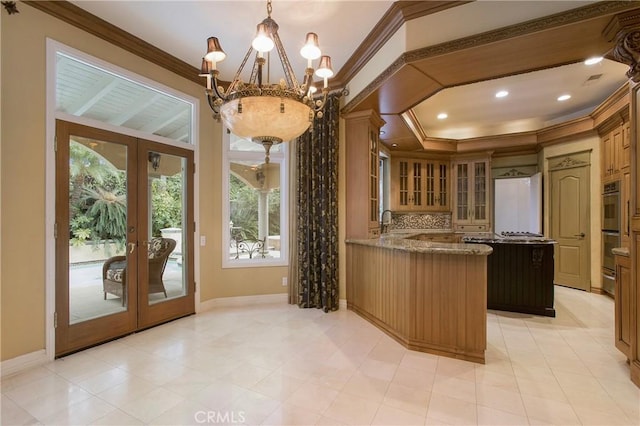 kitchen featuring kitchen peninsula, french doors, crown molding, white refrigerator, and an inviting chandelier