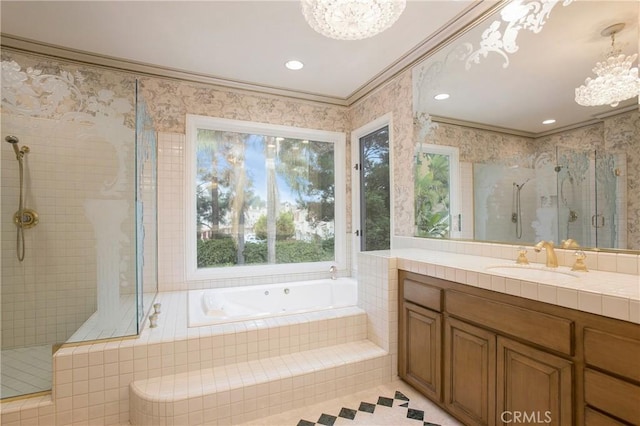 bathroom with vanity, an inviting chandelier, shower with separate bathtub, and ornamental molding