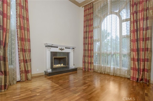 unfurnished living room with hardwood / wood-style floors and a fireplace