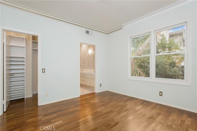 unfurnished bedroom with dark hardwood / wood-style flooring