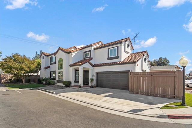 mediterranean / spanish home featuring a garage