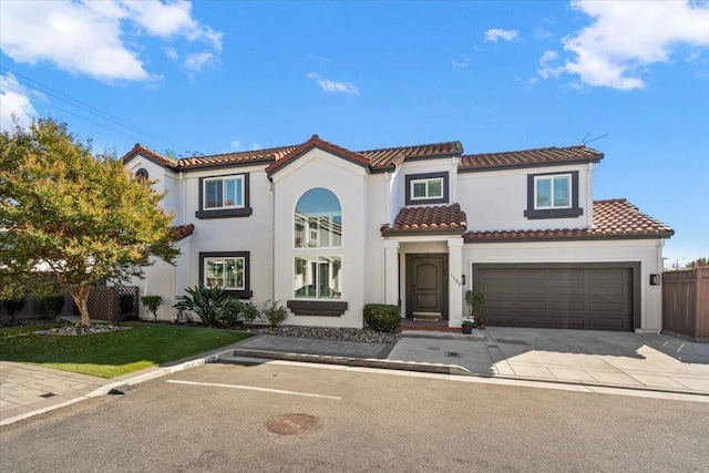 mediterranean / spanish-style home with a garage