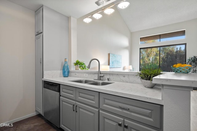 kitchen featuring sink, gray cabinets, stainless steel dishwasher, and vaulted ceiling