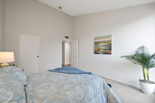 bedroom with a towering ceiling and carpet flooring