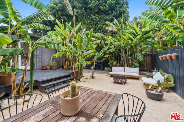 exterior space featuring a fire pit and a wooden deck