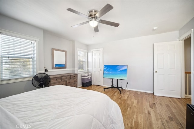 bedroom featuring multiple windows, light wood-type flooring, and ceiling fan