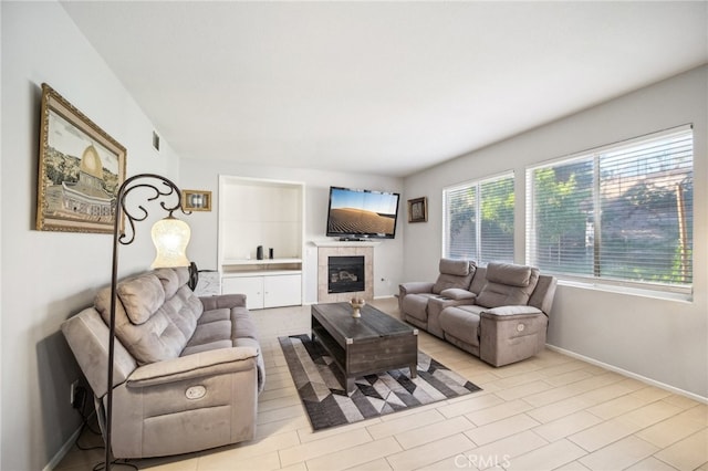 living room featuring a tile fireplace