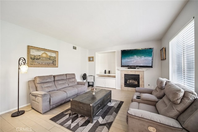 living room with a tiled fireplace