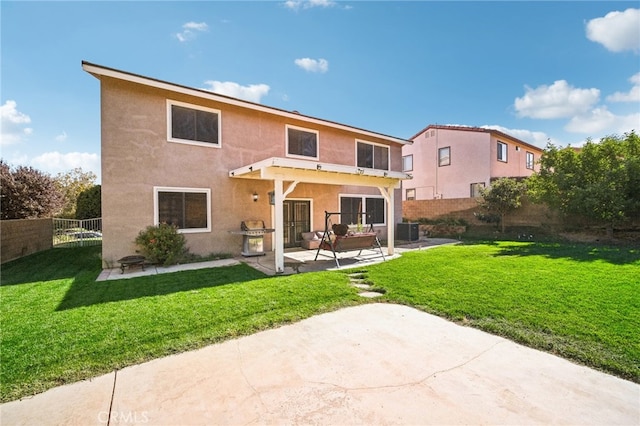 back of property featuring a patio area, central AC, and a lawn