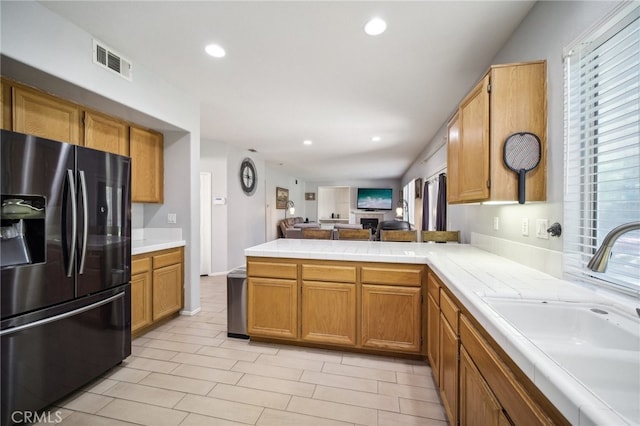 kitchen with sink, stainless steel fridge, and kitchen peninsula