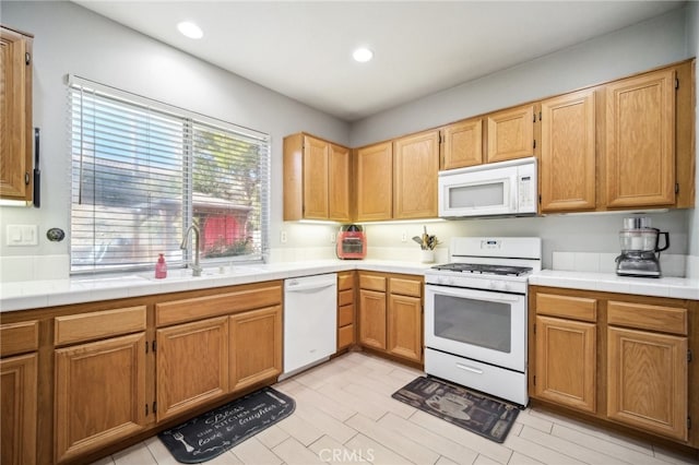 kitchen with tile countertops, sink, and white appliances