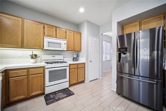 kitchen with light wood-type flooring and white appliances