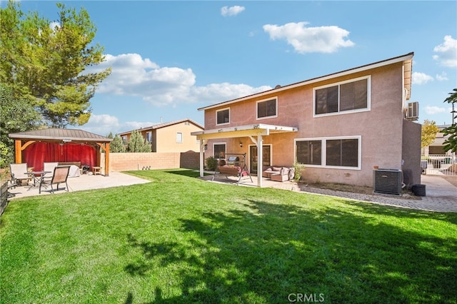 back of property featuring a patio, central AC, and a yard