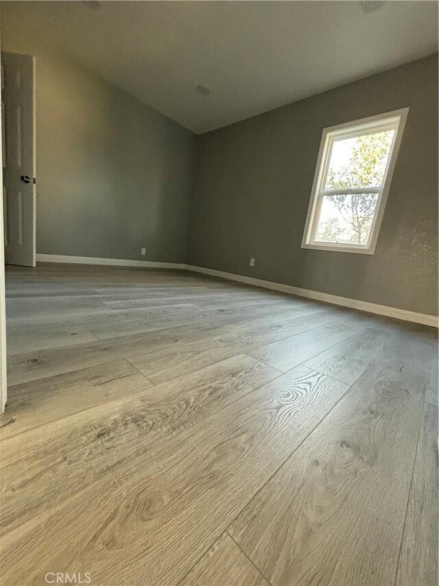 spare room with light hardwood / wood-style floors