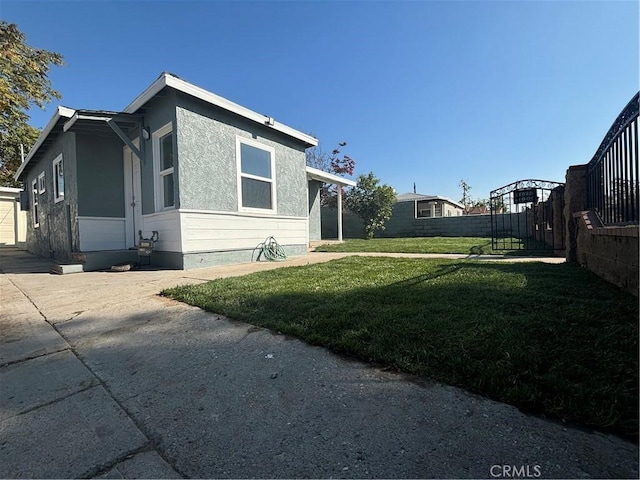 view of side of home with a lawn