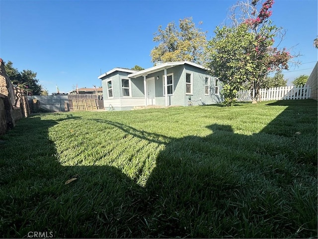 rear view of property with a lawn