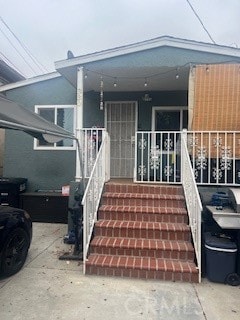 view of exterior entry featuring covered porch