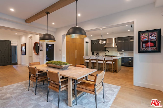 dining space with beam ceiling and light wood-type flooring