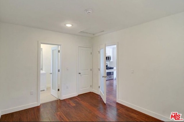 spare room featuring dark hardwood / wood-style flooring