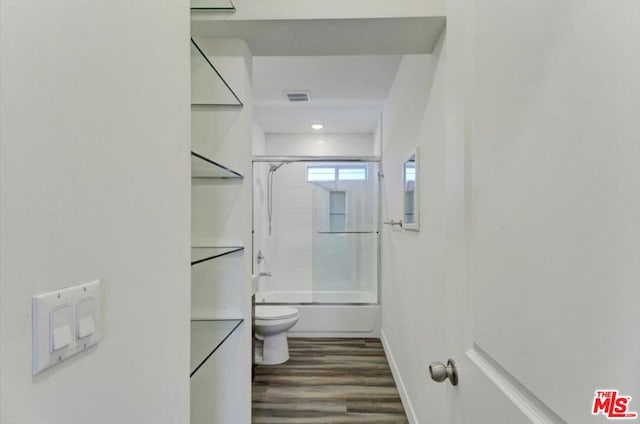 full bathroom featuring vanity, combined bath / shower with glass door, wood-type flooring, and toilet