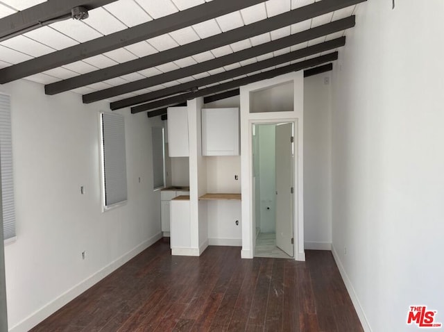 unfurnished bedroom featuring vaulted ceiling with beams and dark hardwood / wood-style flooring