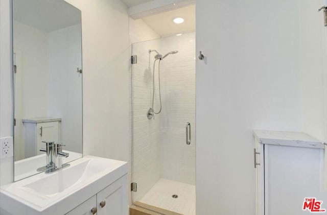 bathroom featuring vanity and an enclosed shower