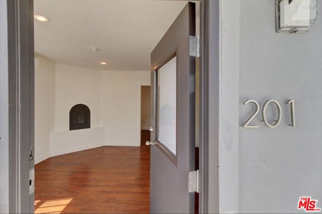 corridor featuring dark hardwood / wood-style floors